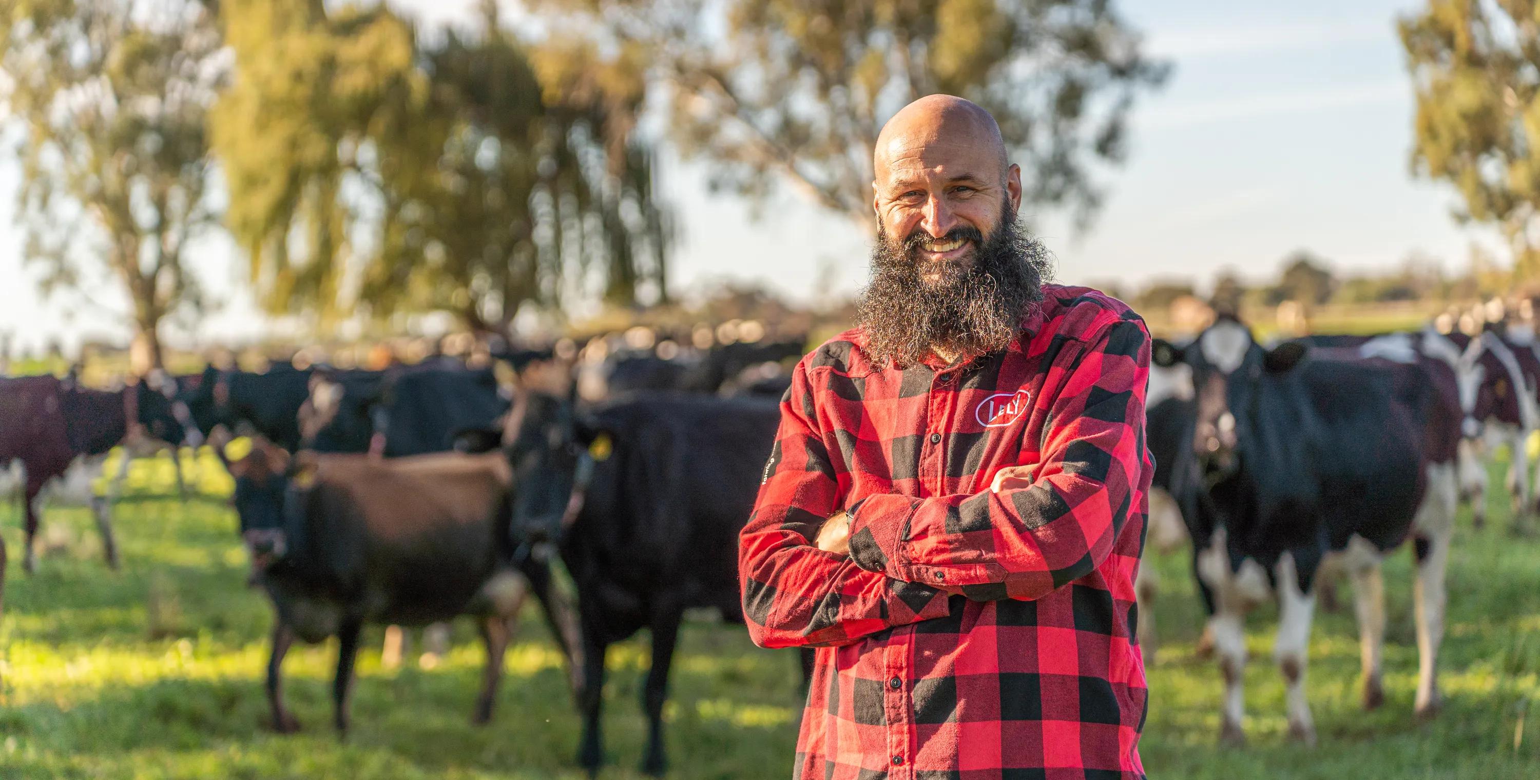 Lely Employee between cows in the paddock