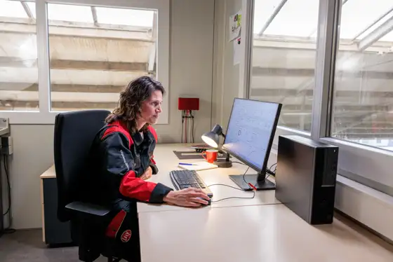 Lely Employee between cows in the paddock