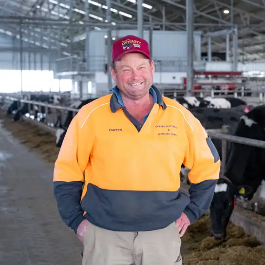 Darren Vickers in his barn in front of the robots