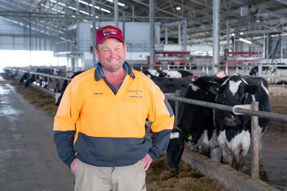 Darren Vickers in his barn in front of the robots