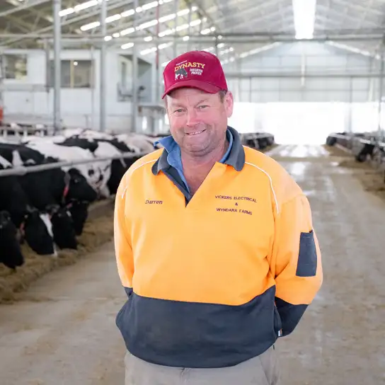 Darren Vickers in his barn in front of the robots