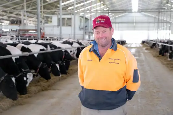 Darren Vickers in his barn in front of the robots